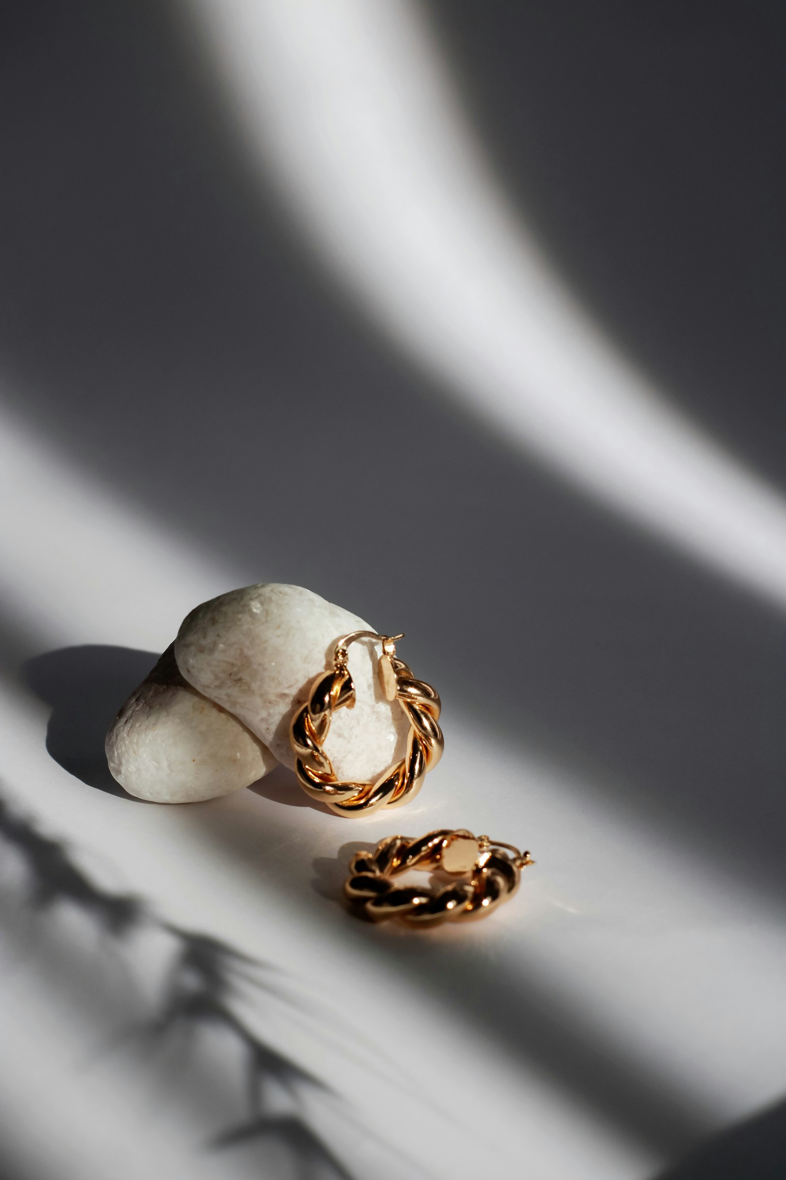 Handcrafted gold jewellery displayed on natural stone